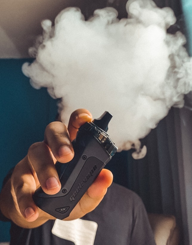 Person Holding a Black Vape